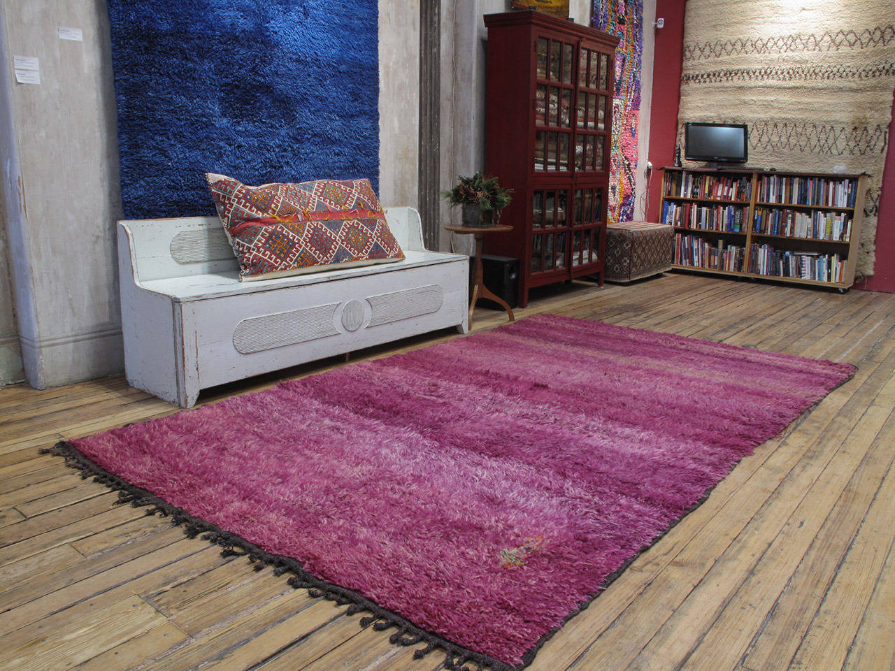 An old Moroccan Berber rug from the Middle Atlas Mountains attributed to the Beni Mguild tribes. Monochromatic rugs, with variations in color intensity and with minimal or no motifs, are typical for this tribe and purple is one of their favorite