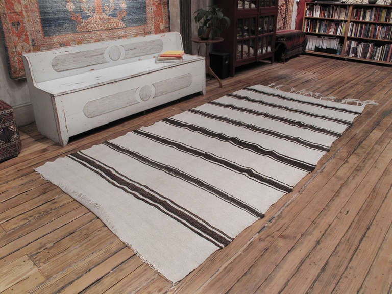 An old tribal flatweave from Central Turkey, woven with jute and goat hair, intended as an everyday floor cover or possibly for use in the fields. Great patina acquired through decades of hard use and very appealing modern graphics. A very nice