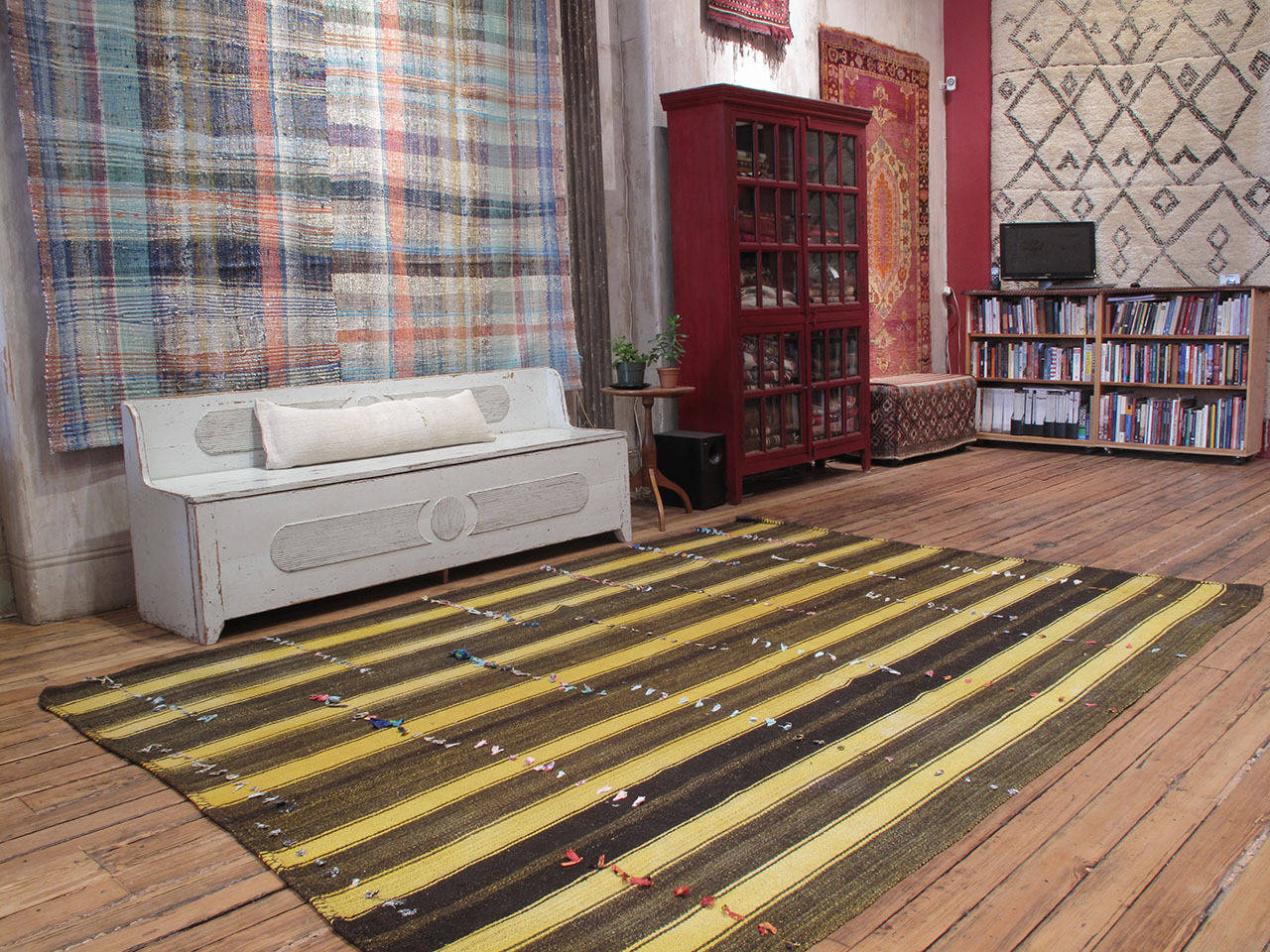 A large, heavy and sturdy flat-weave from Central Turkey, woven in four vertical panels and decorated with so called wish-knots. The yellow color is quite unusual as these simple utilitarian floor covers are mostly woven with natural, undyed wool.
