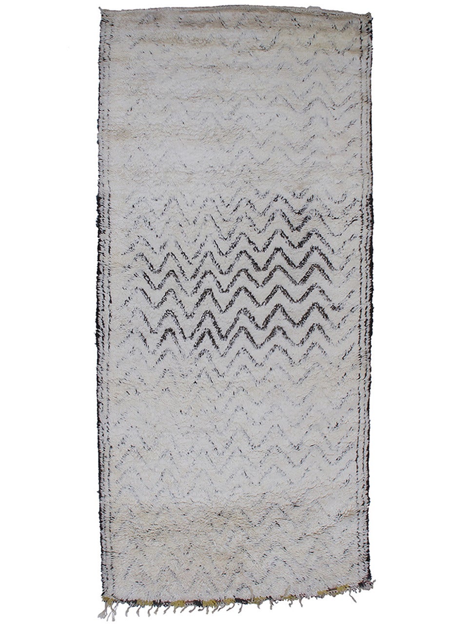 A great Moroccan Berber carpet by the Beni Ouarain tribes of the NE Middle Atlas Mountains, originally intended for use as a bed for the weaver's family.

The design featuring zigzag stripes is highly unusual and is partially covered by the thick