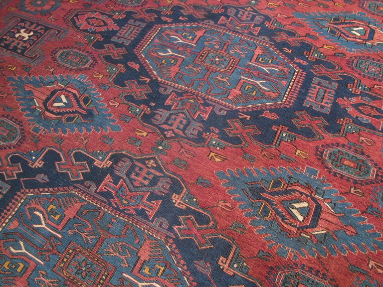 A great antique Caucasian sumak flatweave in large, squarish format, featuring a rare border design and other unusual motifs in the field.