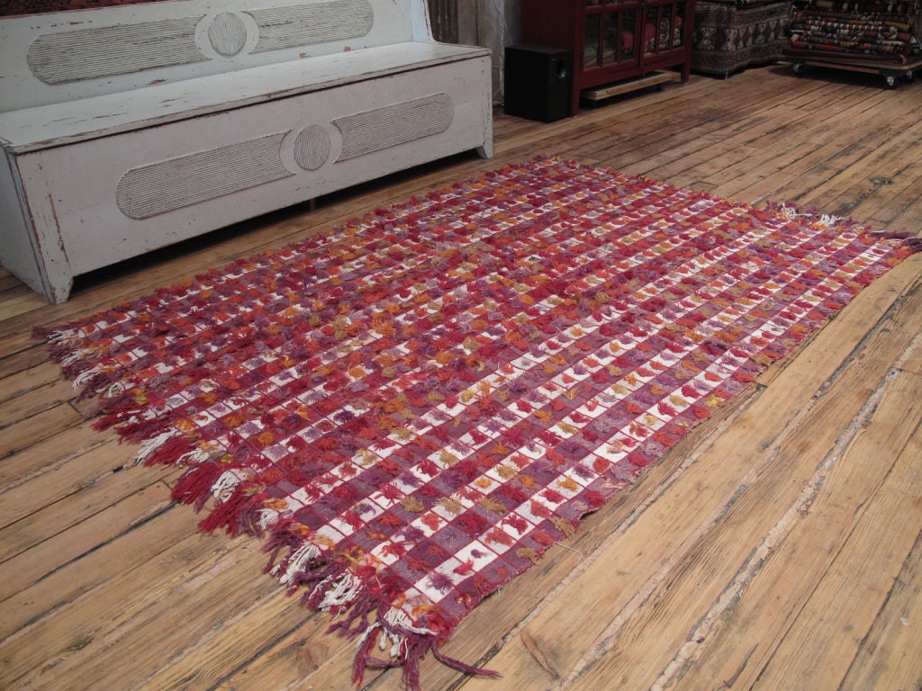 Pardah 'Curtain' rug with Poms. A colorful tribal weaving by Kurdish nomads, used as a curtain or wall hanging in their tents and cottages. It is sturdy enough for use on the floor in a low traffic area as a rug, but it can also be used in many