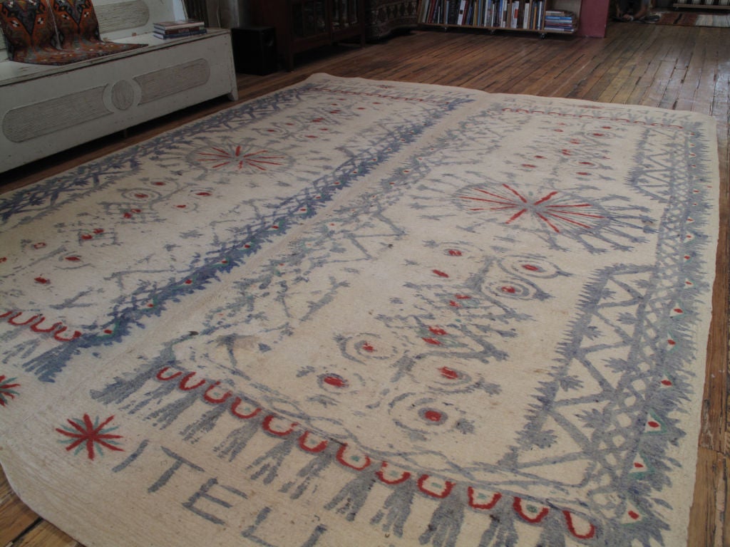 Felt carpet or rug. A pair of almost identical felt rugs, stitched together to make a large, room-size floor cover or carpet. The name of the maker, the client and the date are stamped at the ends of the carpet. Felt carpets or rugs like these would