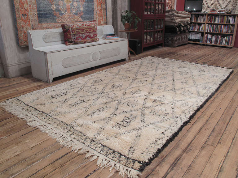 A nice old Moroccan Berber rug by the Beni Ouarain tribes of the Middle Atlas with a more richly detailed design than usual.