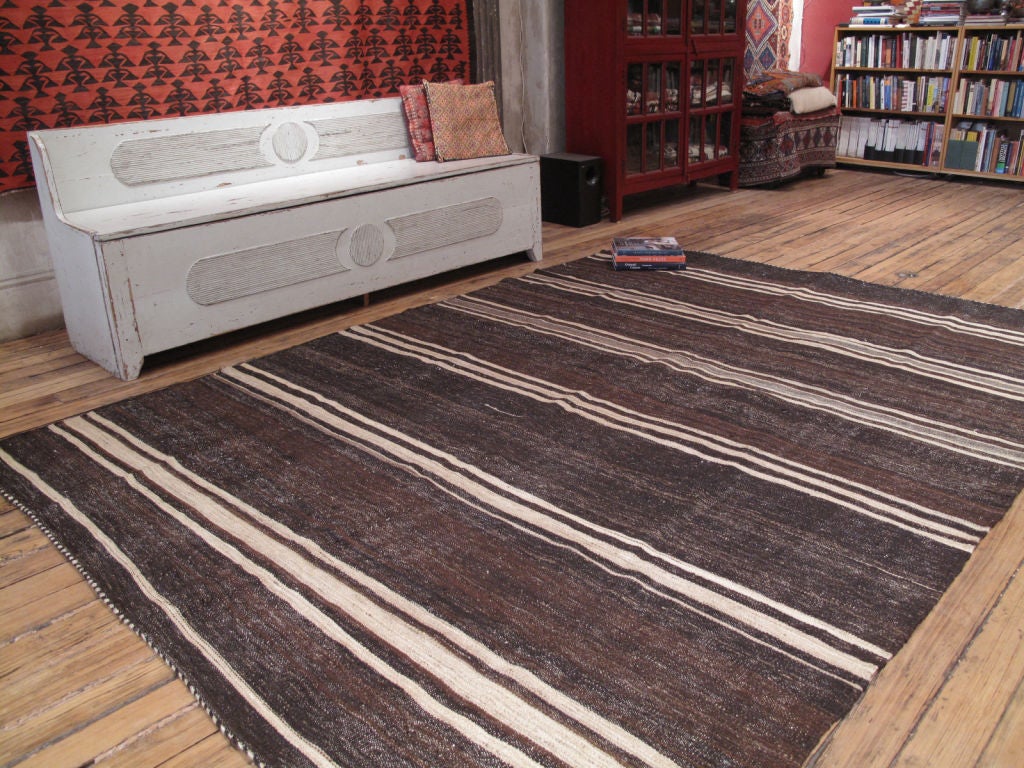 A simple tribal floor cover, woven using un-dyed wool and goat hair with very pleasing natural variations. Great texture. Very sturdy.