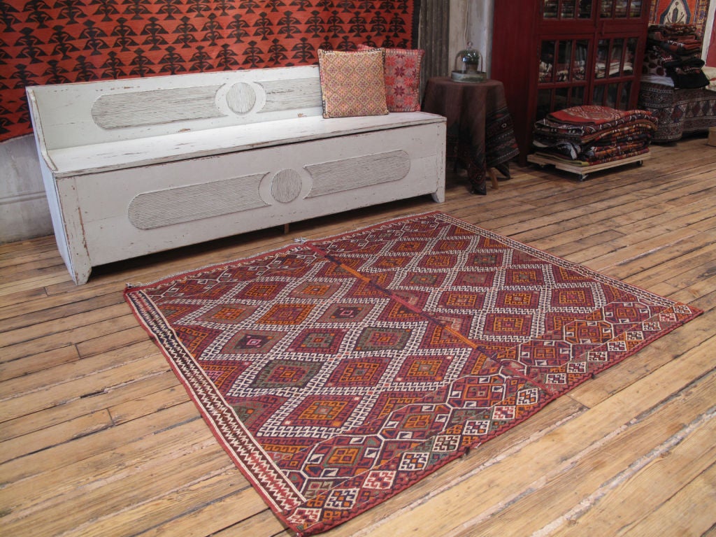Khoy Sumak rug. A very sturdy tribal floor cover or rug by Kurds of Western Iran. Rug is woven in two symmetrical halves as is typical many tribal rugs.