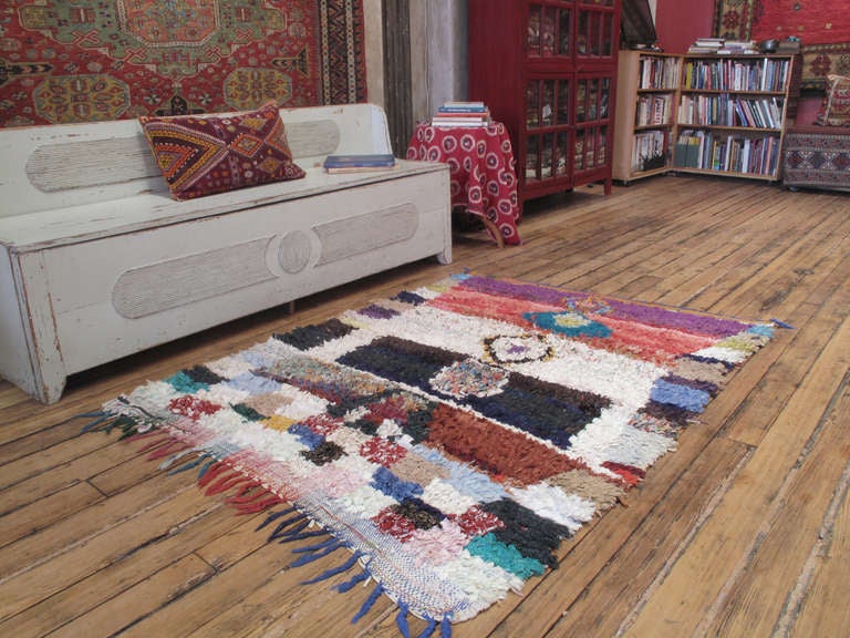 A Moroccan rug, woven entirely with cut-up pieces of fabric from old clothes - boucherouite means rag or torn cloth in Moroccan Arabic. A relatively recent phenomenon, such weavings are products of socio-economic changes in Moroccan society, with