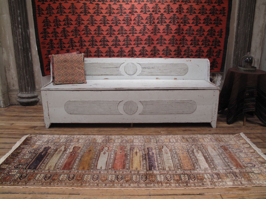 An old Turkish rug with multiple prayer niche design, called 
