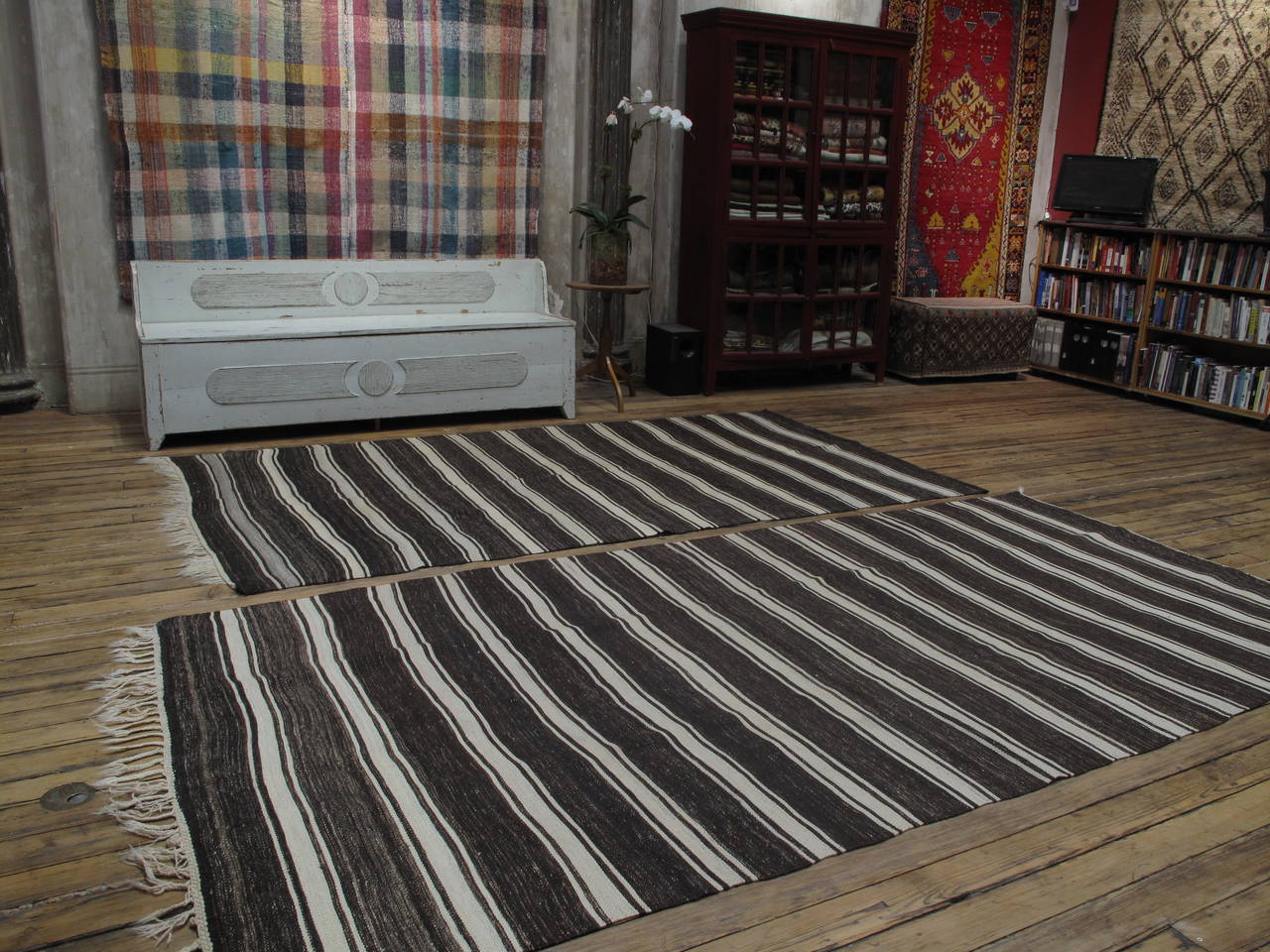 A pair of simple old tribal floor covers from Central Turkey, woven with natural dark brown and ivory wool and goat hair (no dyes). These are very sturdy weavings, suitable even for high traffic. They can be placed side-by-side, or easily stitched