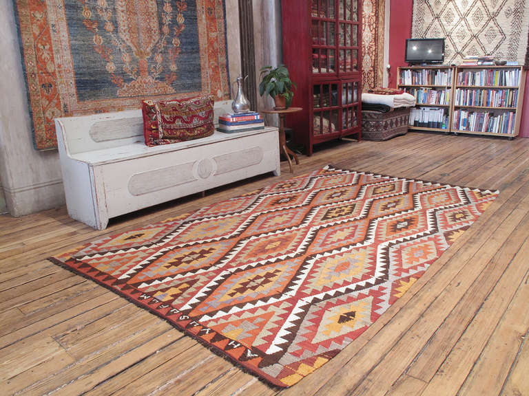 A lovely tribal kilim from the Taurus Mountains in Southern Turkey with a simple, classical design, but with the most unusual inscription by the weaver. Instead of simply spelling what is probably her fiancee's name, she made her longing known by