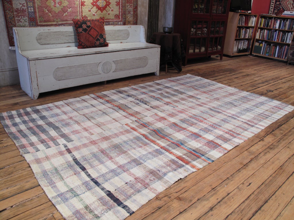Pala Kilim rug. A simple, old tribal floor cover or rug, made for everyday use with a soft, pastel color palette.