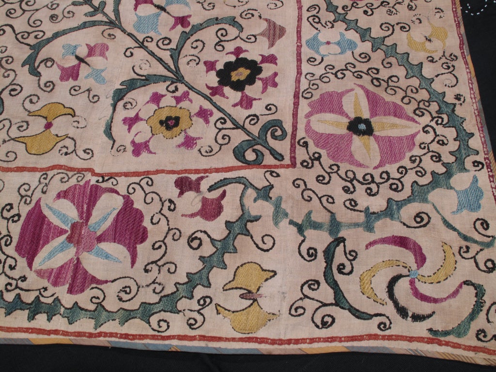 Beautiful old Uzbek suzani with swirling floral motifs.