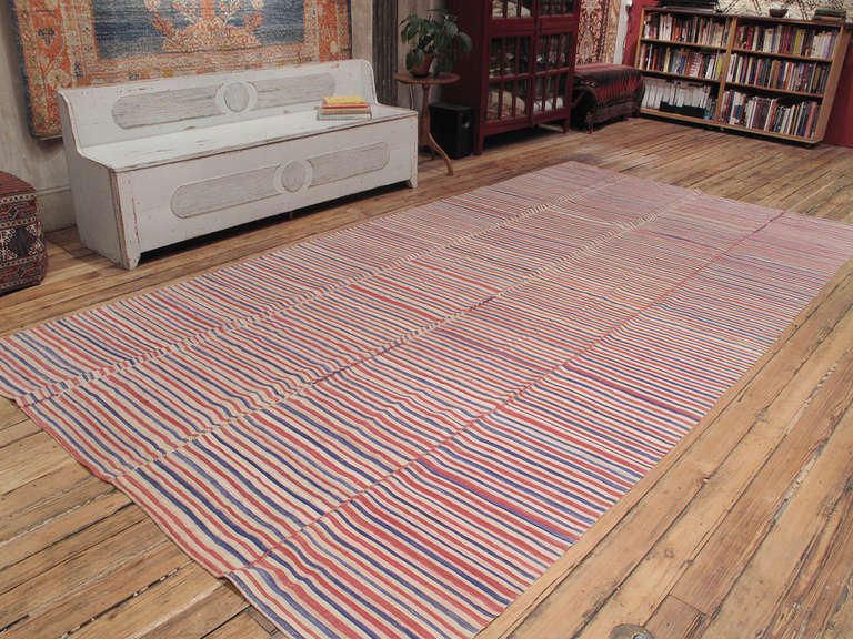 An older example of this type with colorful stripes, rather than the usual undyed brown ivory combination, with colors faded to perfection due to age and use.

This is a finer weaving and it should ideally be used in a low traffic spot.