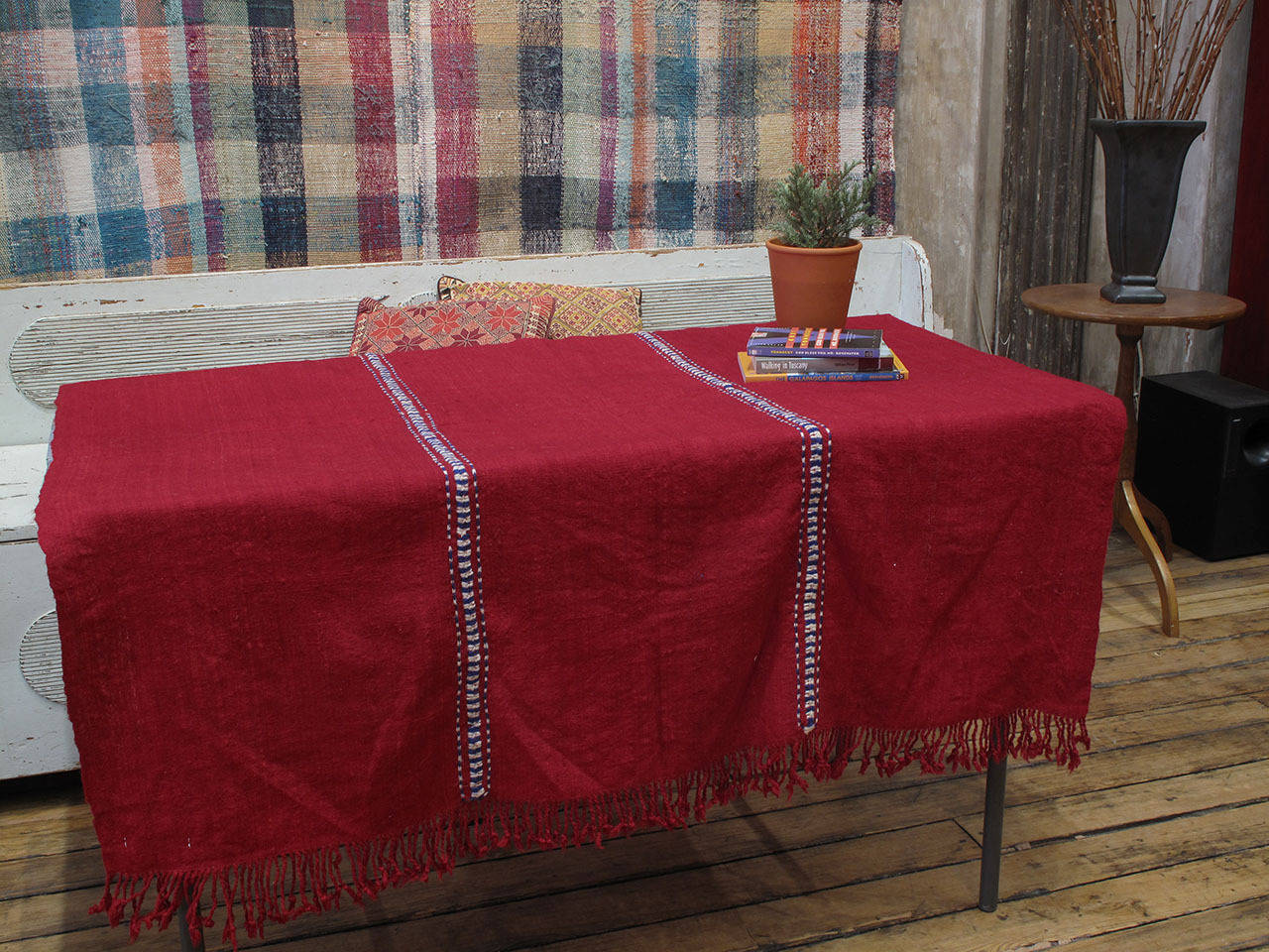 A small tribal cover with a delicate and light-weight weave, possibly used as a cradle cover or baby blanket. The intricate stitching between panels and the braided fringes are very finely done.