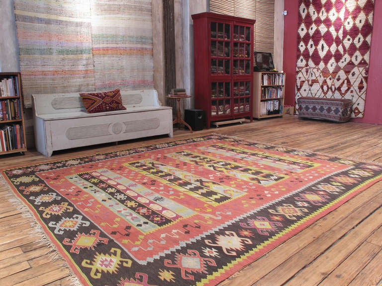 Balkan Kilim rug. An old Kilim rug in large format from the Balkan Peninsula (Serbia-Bulgaria region), in characteristic colors, featuring a somewhat unusual design.
 