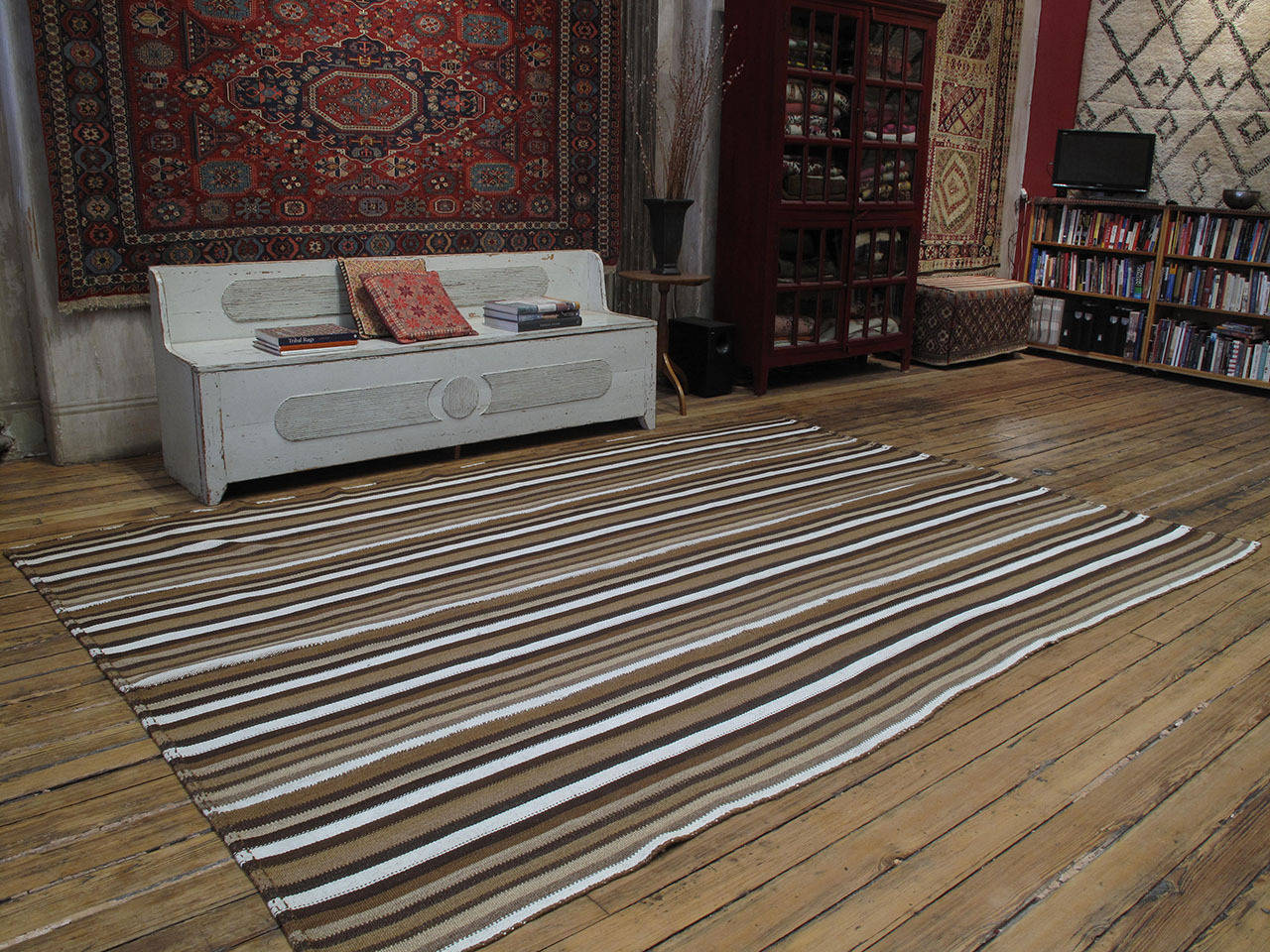 Kilim rug with vertical stripes. A beautiful old tribal Kilim rug from South Eastern Turkey woven with wool in alternating tones of natural brown and white cotton. Most likely intended as a simple, everyday floor cover or rug, it has wonderful