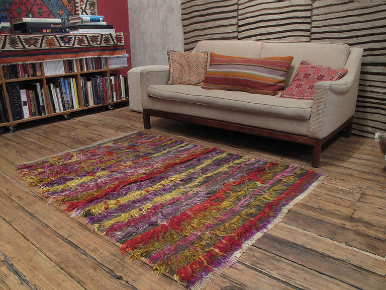 An old tribal rug with loosely knotted, shaggy pile in angora goat hair, a silky, shiny fiber better known as mohair. Such rugs were used as floor covers, blankets or wall hangings to provide warmth and comfort. This one certainly stands out with