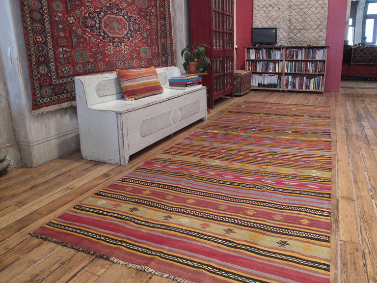 A superb old tribal flat-weave from Central Turkey, woven in wide runner format, with alternating bands and stripes in many colors, richly adorned with brocaded motifs and tassels. One of the best examples of this type that we have ever handled.