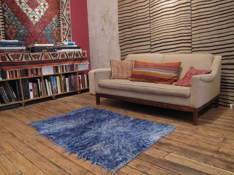 An old tribal rug from West Central Turkey, coarsely woven with long strands of colorful angora goat hair (mohair.) Such rugs were used as beds, blankets and wall covers to provide warmth and comfort in village homes. Single color pieces like this