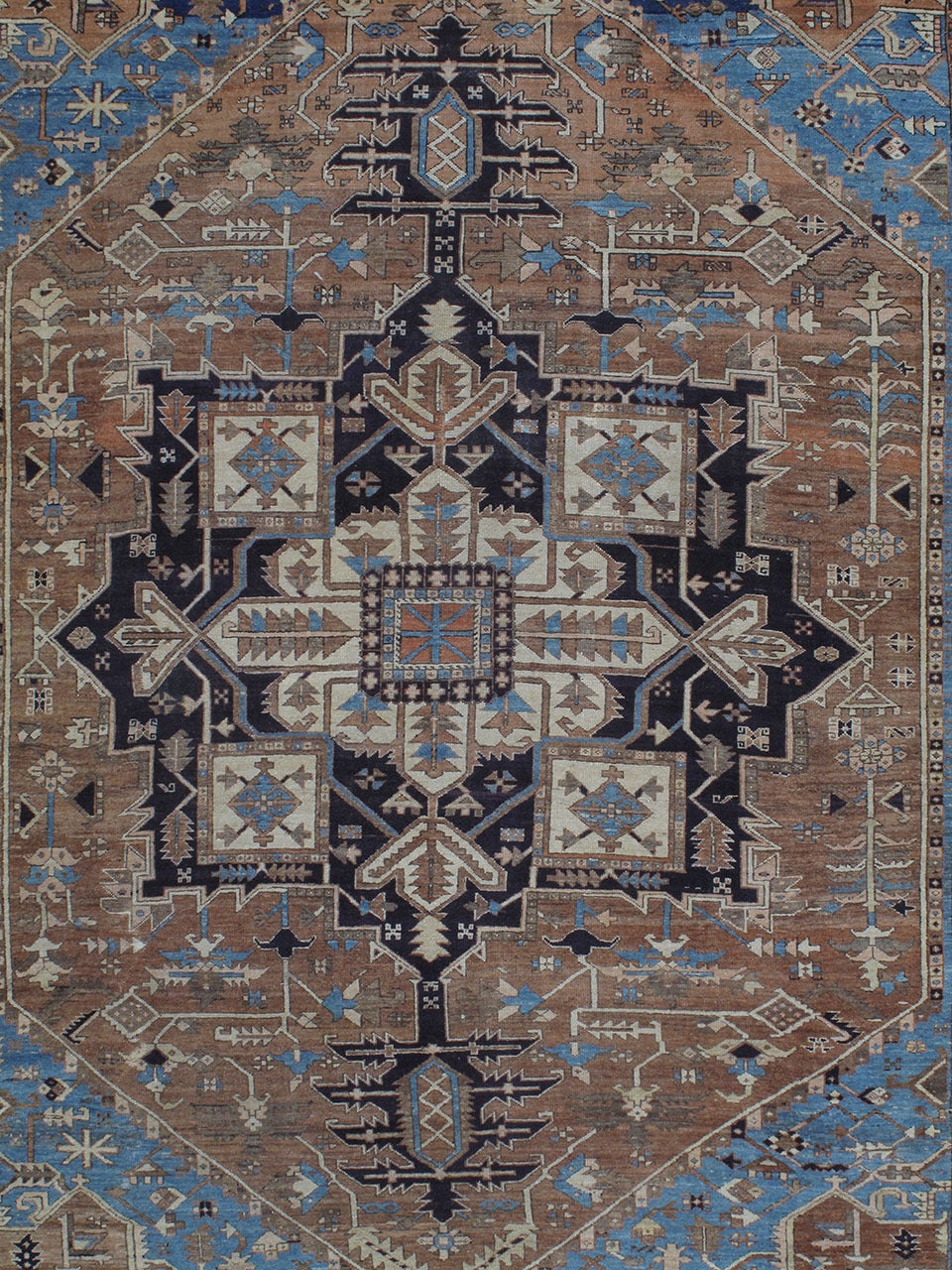 A very handsome antique carpet from the Heriz region of Northwestern Persia, a type that has been very popular in the West for over a century. The classical design is rendered in a very geometric style. The color palette is softer than usual,