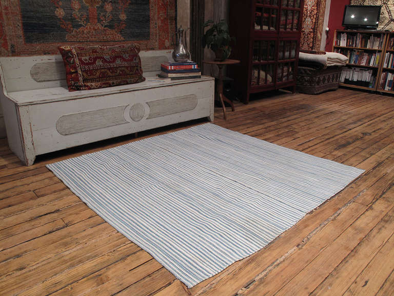 An old tribal cover by the Shahsavan of Azerbaijan, woven with hand-spun cotton in alternating stripes of indigo and white. Wonderful patina and blanket-like handle. Sturdy enough to be used as a floor cover in low traffic. Would be ideal as a bed