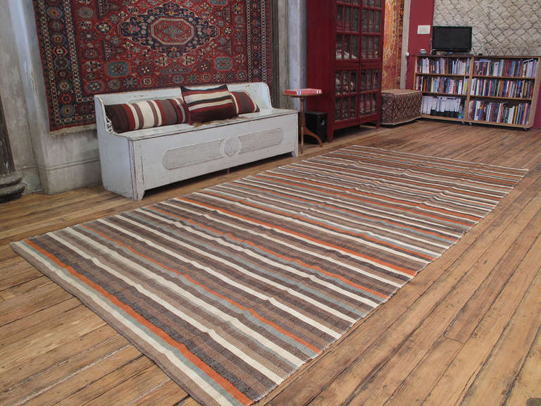 Striped cover rug. A lovely old flat-weave rug from Western Turkey, woven in panels on a narrow loom. It can be used as a floor cover or rug in a low traffic area, but it is also light enough to be used as a bedspread. Rug has great color variations