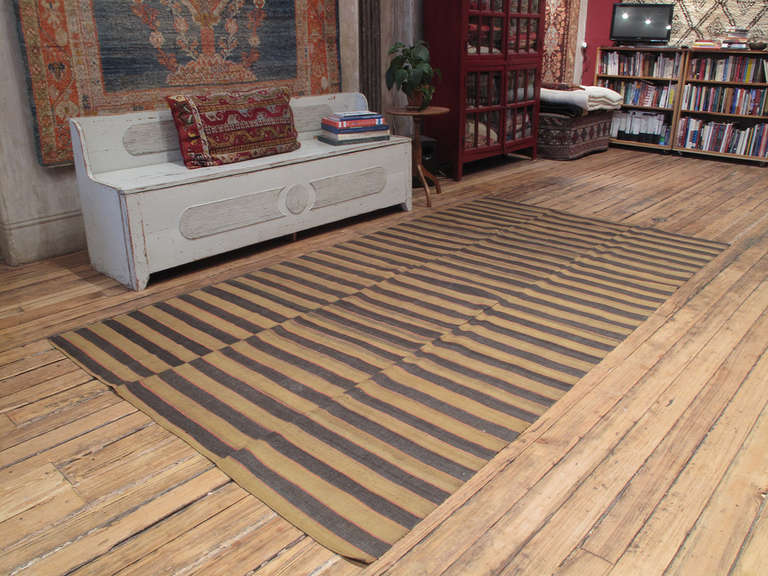 Banded cover rug. A lovely old flat-weave rug from Western Turkey, woven in panels on a narrow loom. It can be used as a floor cover or rug in a low traffic area, but it is also light enough to be used as a bedspread. Rug has great color variations