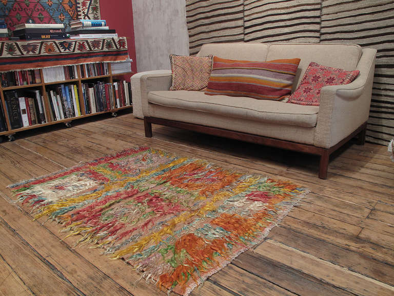 An old tribal rug with loosely knotted, shaggy pile in angora goat hair, a silky, shiny fiber better known as mohair. Such rugs were used as floor covers, blankets or wall hangings to provide warmth and comfort. The colors have become soft and