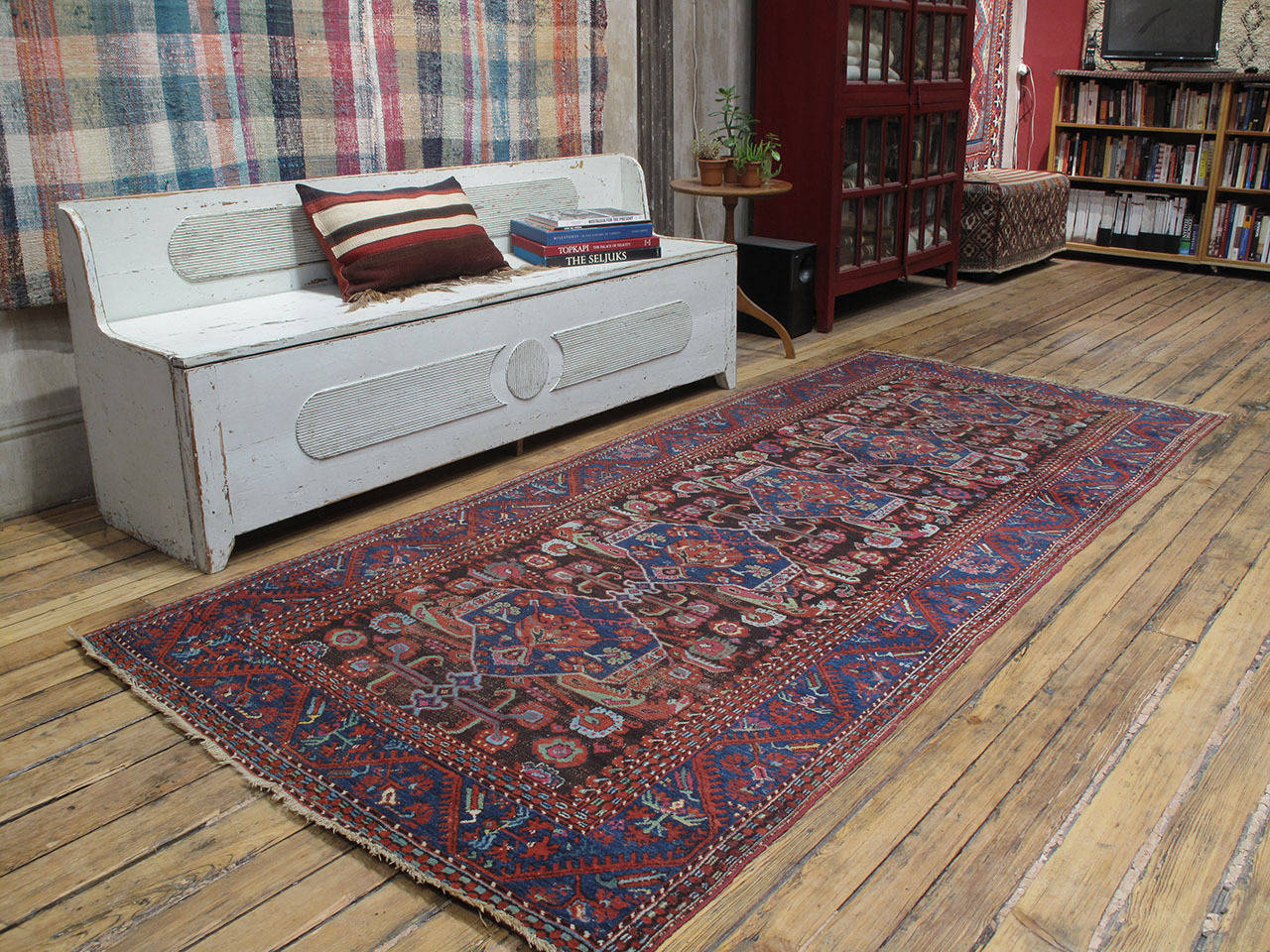 Antique Kula long runner rug. An older example of this well-known type of rug from one of the most prolific weaving centers of Western Turkey. With tulips and carnations and a profusion of other stylized floral forms, this antique village rug is a