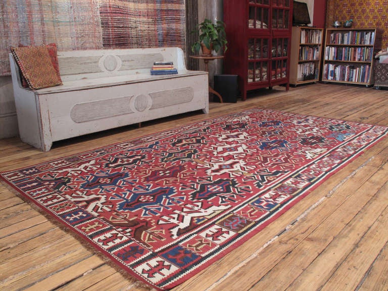 Antique Kuba Kilim rug. A very fine example of this iconic type of Caucasian flat-weave rug with a great range of colors, an unusual border and brocaded charm motifs all-over. One of the finest Caucasian kilims we've ever handled. Rug is in