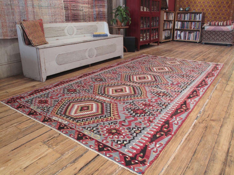 Eshme Kilim rug. A tribal flat-weave rug from Western Turkey featuring a classical design of hooked diamonds with great use of positive-negative imagery.