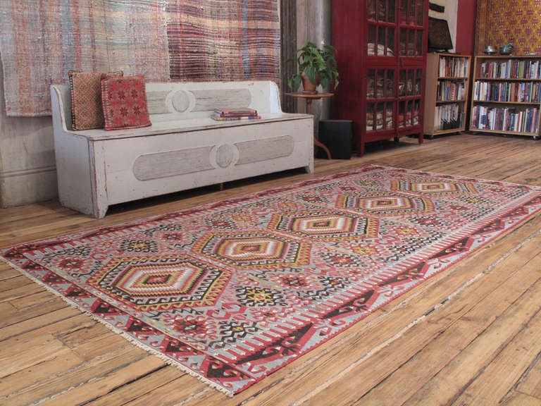 Eshme Kilim rug. A tribal flat-weave rug from Western Turkey featuring a classical design of hooked diamonds with great use of positive-negative imagery.