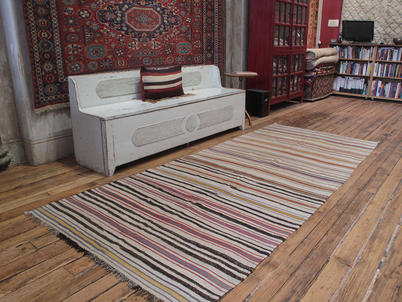 An old tribal flat-weave from West-Central Turkey woven with colorful stripes on a natural ivory background. An older example of this type which displays a more care-free style of weaving or notice the 