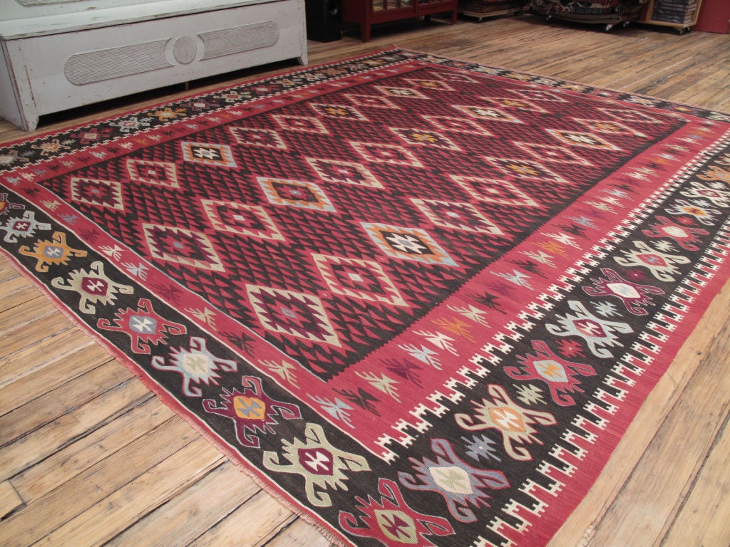 Large Balkan Kilim rug with rare and striking design.