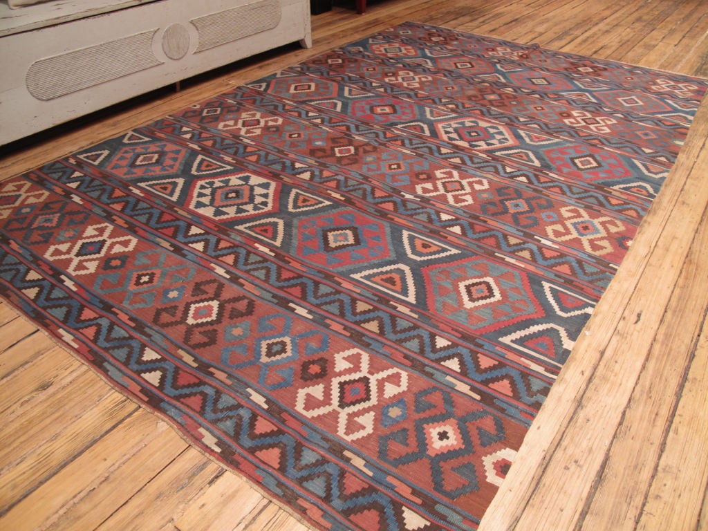 Shirvan Kilim rug. A classical Caucasian kilim rug, not old enough to be antique but almost there. A softer and cooler color palette.