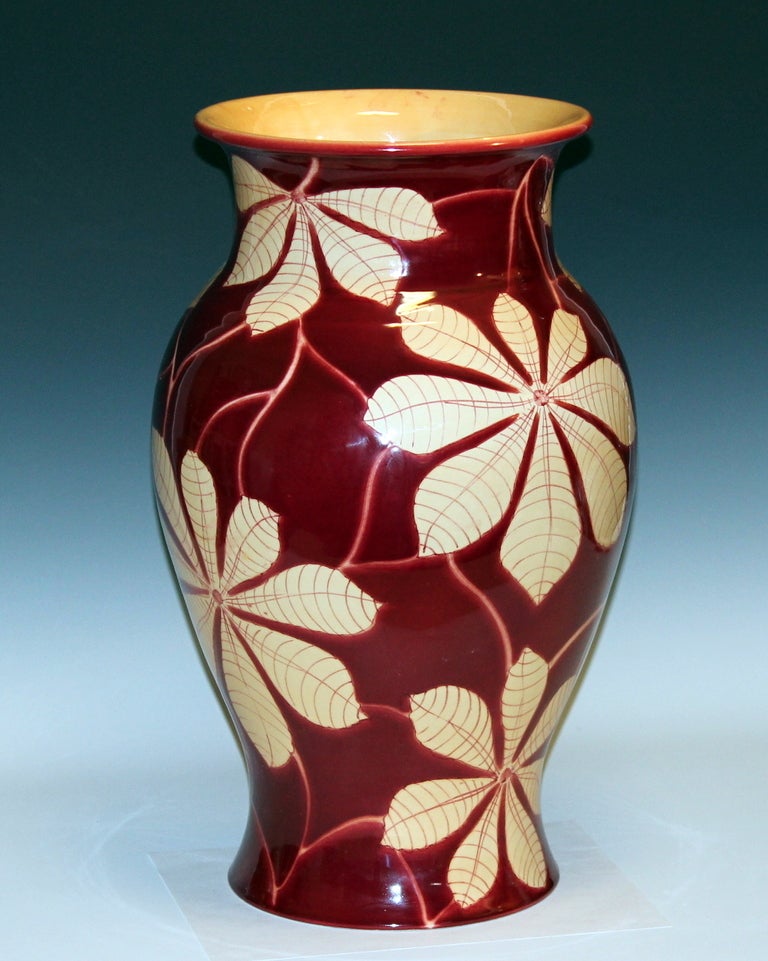 Large vintage hand turned Italian pottery vase by Bellini for the Wannamaker's department store. With exotic floral scroll on a deep oxblood ground. 19