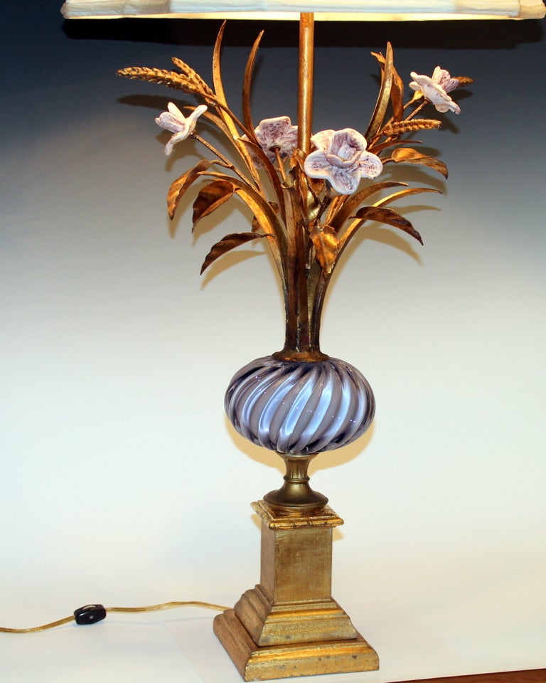 Vintage Italian vase with Murano glass body and blossoms on gilt wood base with gilt tole foliage.