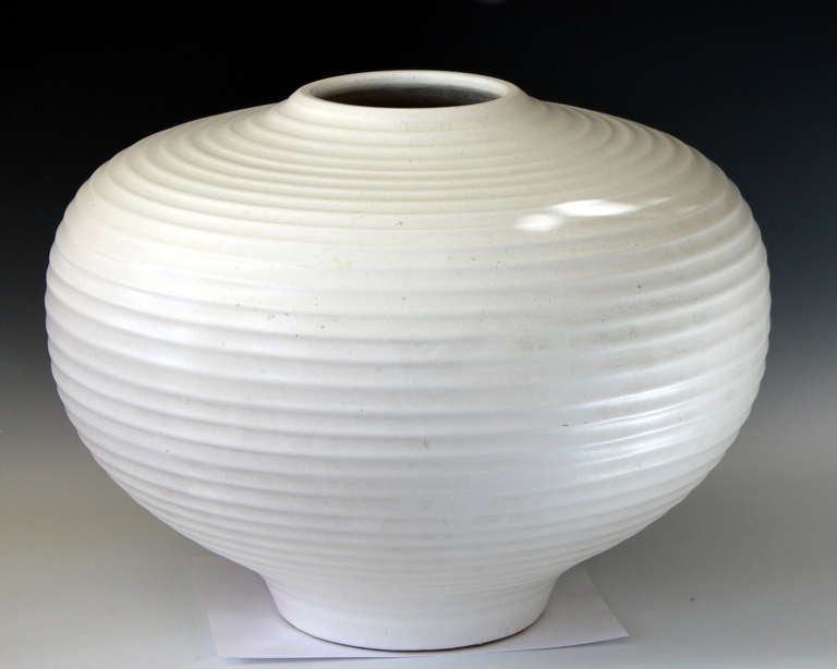 Large art pottery vase in satin white glaze with pronounced ribs. Circa 1980's, 1990's. 14