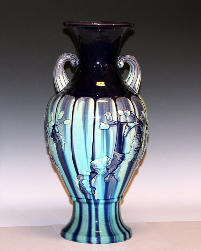 Large Kyoto Pottery vase in segmented form with applied relief floral scroll and brilliant purple over aqua/turquoise crackle glaze, circa 1910s. Measures: 18 1/2