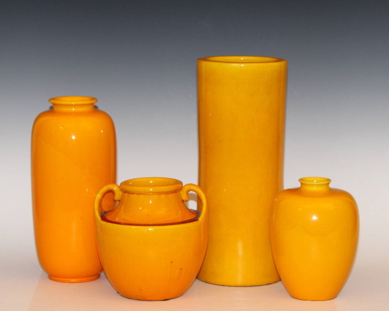 Four hand thrown Awaji Pottery vases in glowing yellow glaze, circa 1910-1930.
Tallest is 12