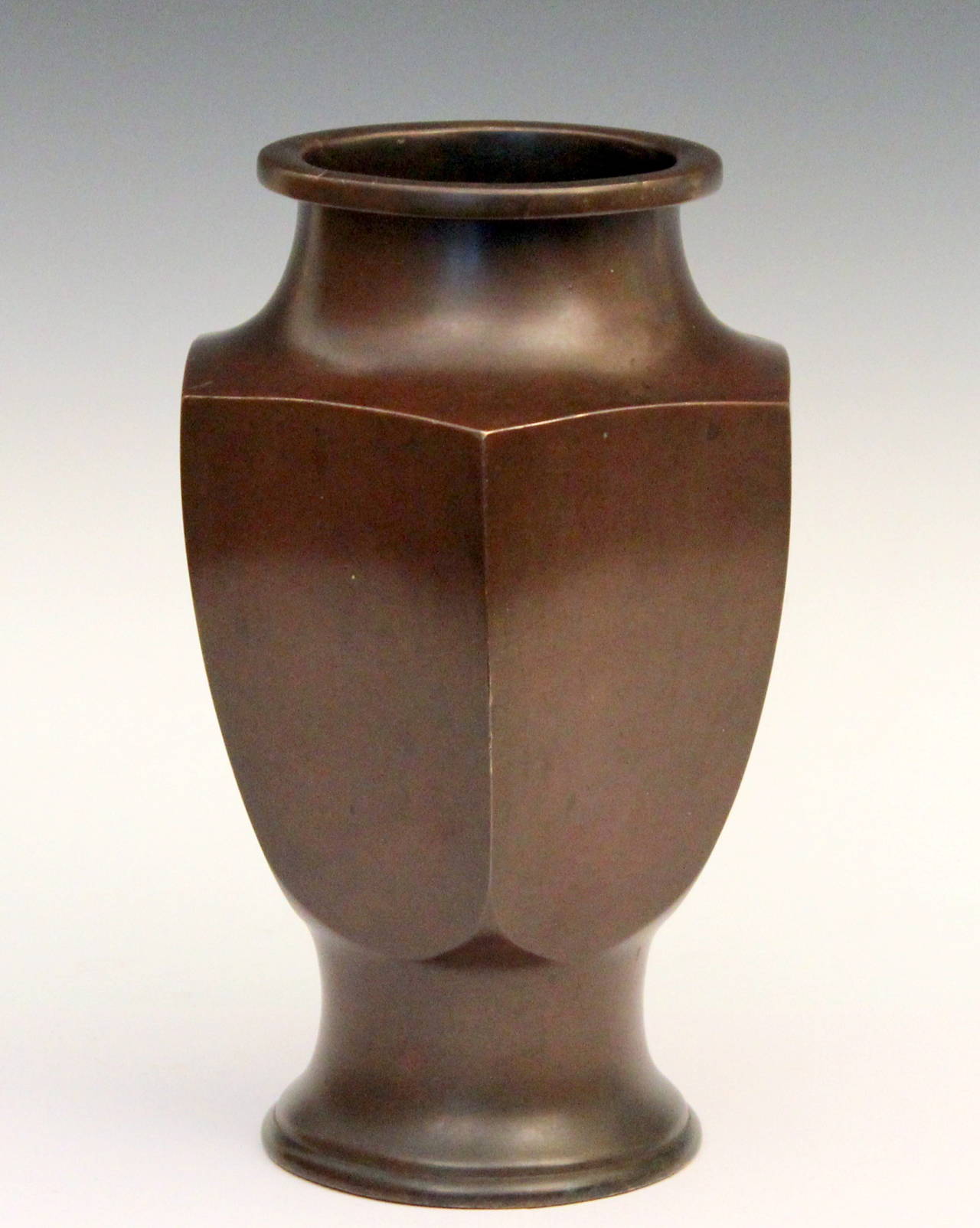 Japanese bronze vase in faceted hexagonal form with warm reddish brown patina, circa 1930s. Measures: 12" high, 7" across facets, 8" across corners. 9+ pounds. Good vintage condition, a few bumps and a light ripple in one side, as