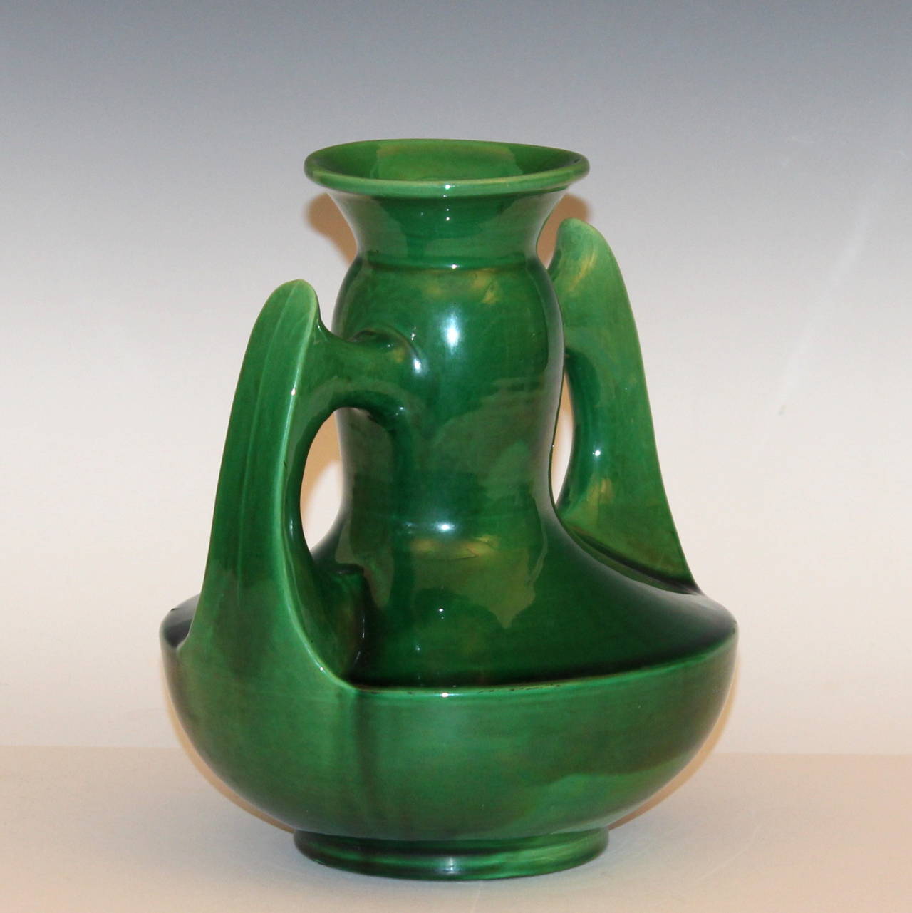 Awaji Pottery vase in Art Deco form with sweeping and pointy wing handles and bright green glaze, circa 1920s. Measures: 9