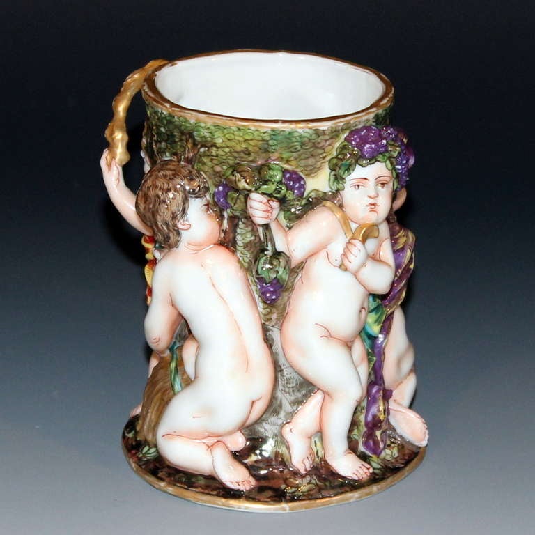 Antique Capodimonte brush pot featuring putti playing at adult pusuits. Fine detail and great color. Figures in 2/3 deep relief. Impressed numerals on base. 4
