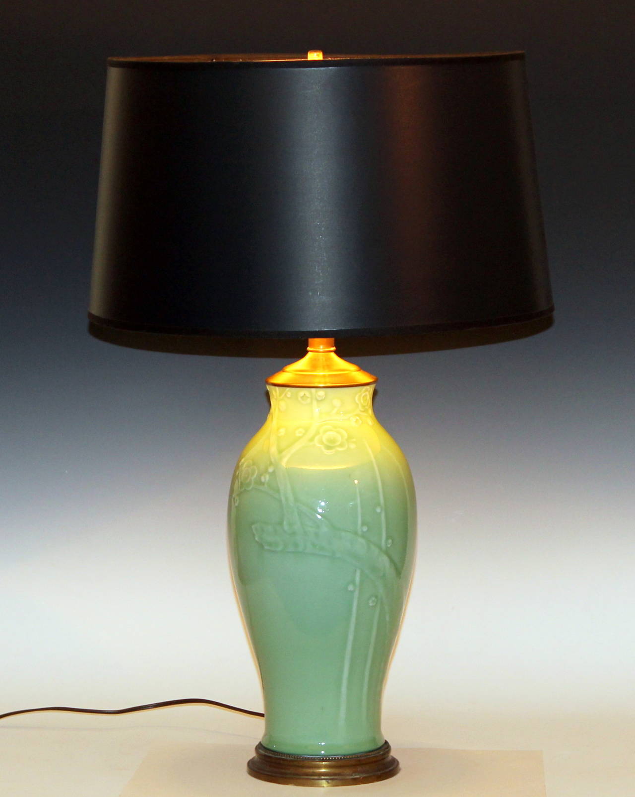 Vintage Japanese porcelain vase converted to lamp with carved plum blossoms and light green celadon glaze. Circa 1960's. 3 way switch. 29