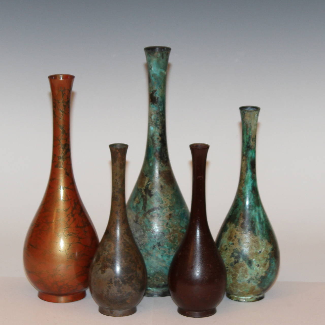 Collection of five Japanese bronze bottle vases with various colored patinas, circa mid/late 20th century. 7 3/8 to 11 inches high. Excellent condition.