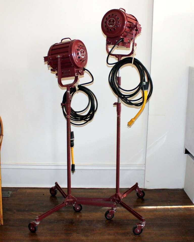 Really nice pair of industrial quality, vintage stage/studio flood/spot lamps by Mole Richardson, the 407 model Baby Solarspot, circa 1960. Original burgundy paint, labels, and 25' heavy duty cords. Folding tripod stands break down for portability.