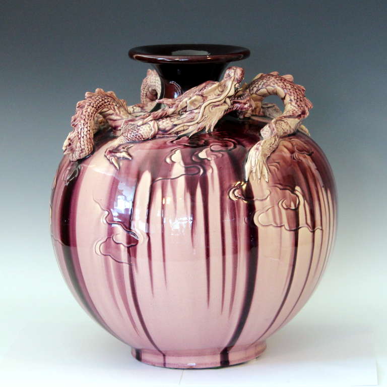 Large Kyoto pottery vase with aubergine drip glaze and full round applied dragon clutching the flaming pearl at the shoulder. Circa 1910. 14