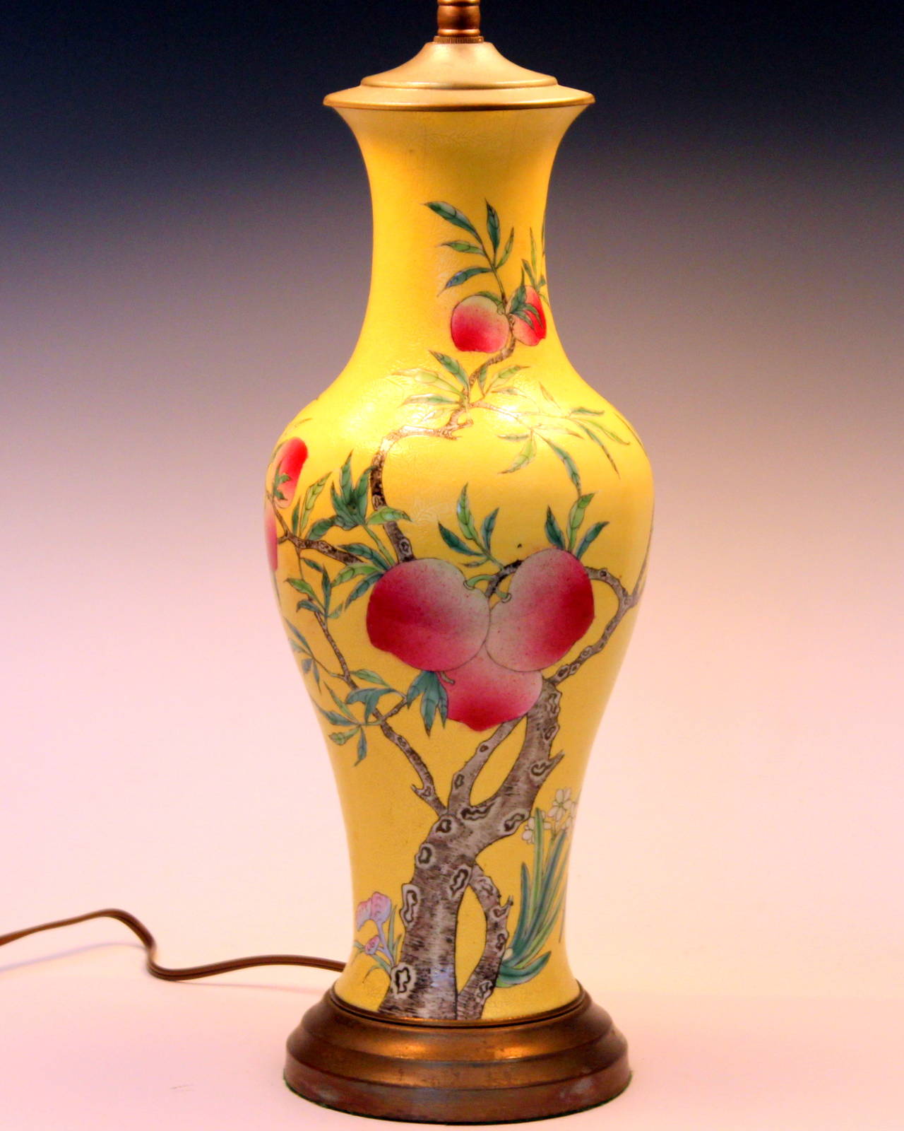 Good antique Chinese porcelain peach vase lamp depicting nine peaches ripening on the tree and a single bat on an incised yellow ground. Qianlong six character mark in over glaze red. 19th century. Vase is 13 1/2