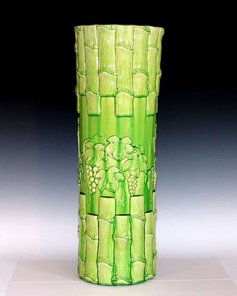 Antique Kyoto pottery umbrella stand with applied bamboo borders and grape vine motif in electric lime/chartreuse glaze. 