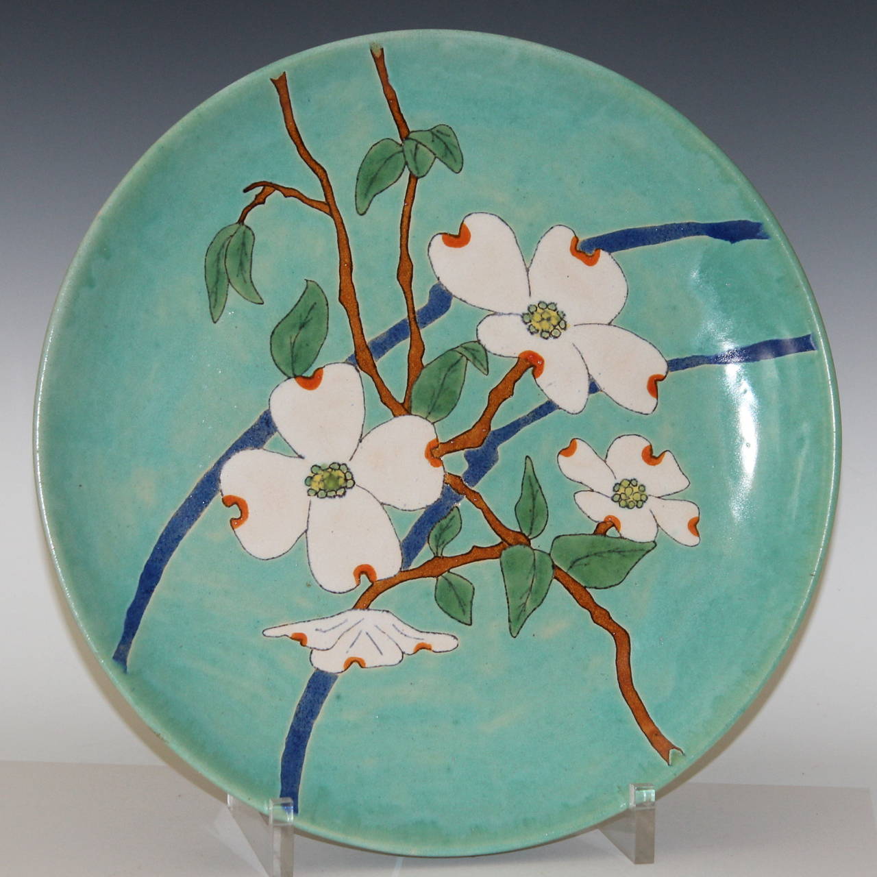 Large San Jose Mission pottery bowl or charger, circa 1930s. Decorated with dogwood blossoms on a turquoise/aqua ground. Signed on back with San Jose Mission aloe plant mark. 14 3/4